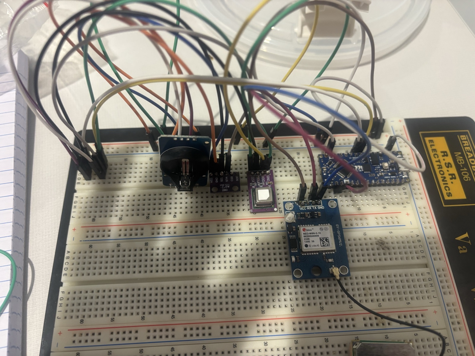 Breadboard with a GPS module, sensors, and a small microcontroller wired together