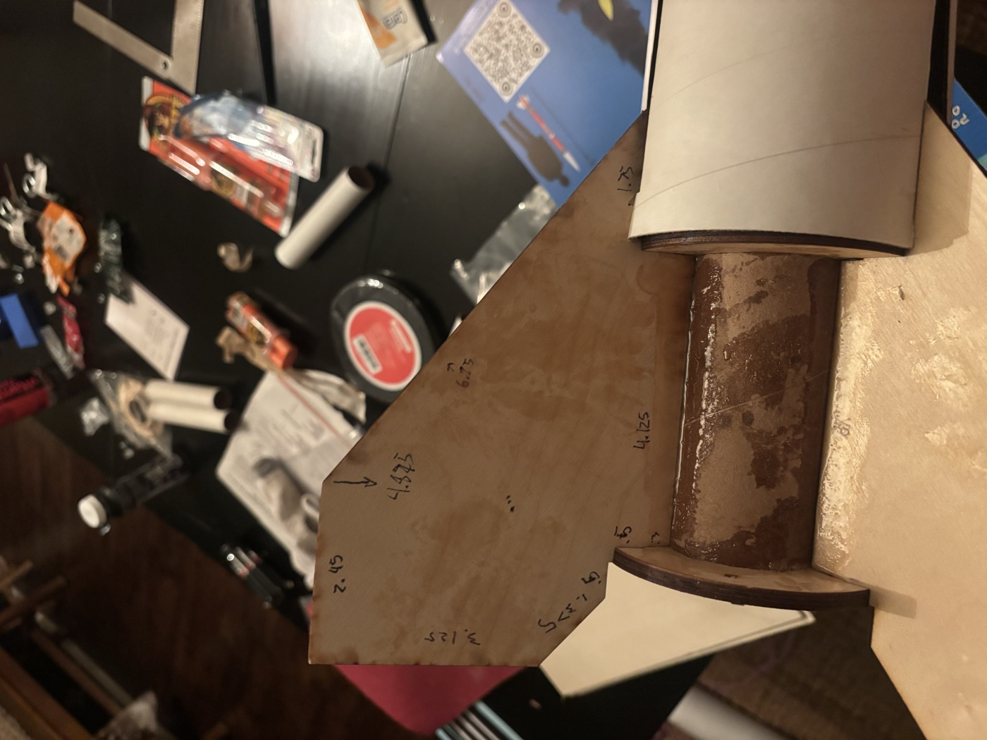 A birch fin with a marked tab fitted against the motor mount tube